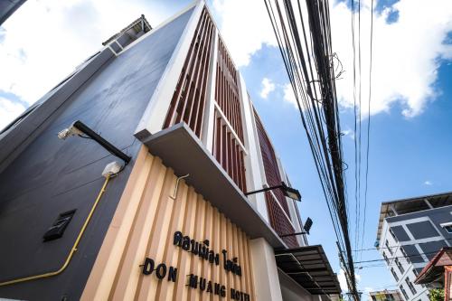 a tall building with the words boom alpha on it at Don Muang Hotel in Bangkok