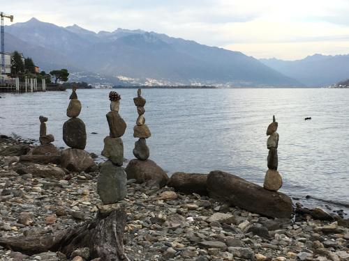 a group of cairns sitting on the shore of a lake at Hotel Garni Rivabella au Lac in Brissago