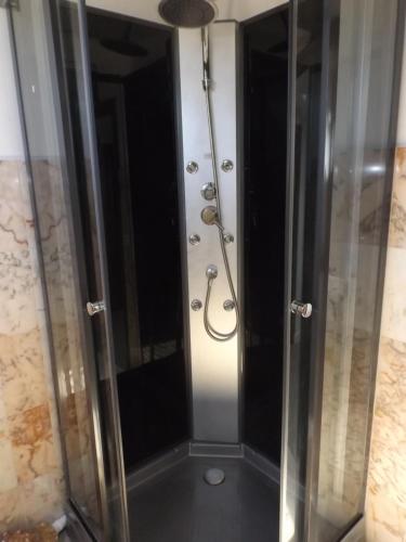 a shower with a glass door in a bathroom at Le gite des Menhirs in Mont-Saint-Éloi