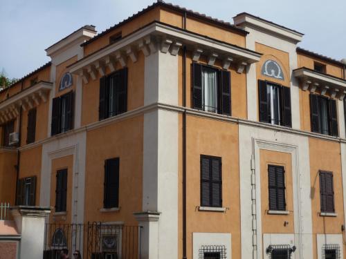 an orange and white building with black windows at My Bed Vatican Museum in Rome