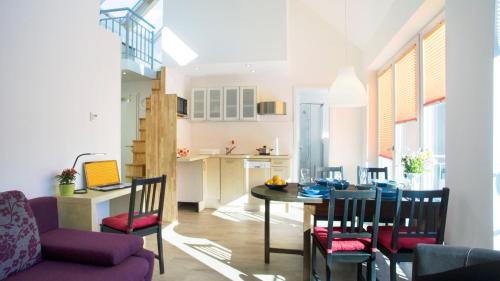 a kitchen and dining room with a table and chairs at Apartment11 Wartburg in Cologne