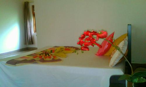 a bedroom with a bed with flowers on it at River Retreat Sigiriya in Sigiriya