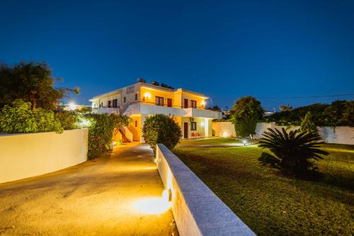 a house with lights on the side of a driveway at Angela Studios Pefkos in Pefki
