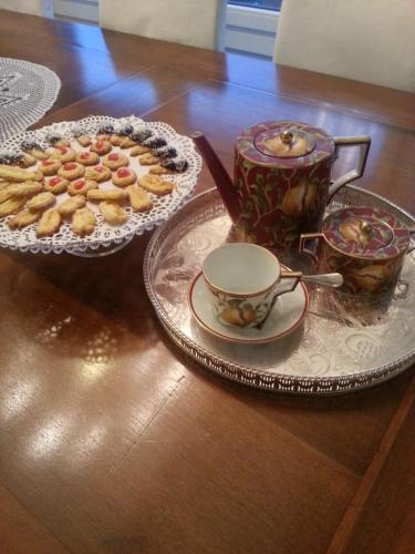 a table with two plates of food and a cup of tea at Foresteria Villa Margherita in Colico