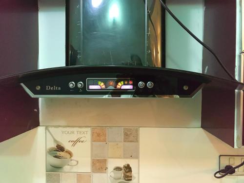 a microwave oven on top of a counter with a bowl at 3 Bed Javed Apartment in Karachi