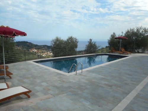 a swimming pool with a view of the ocean at A Baracca du Pei in Imperia