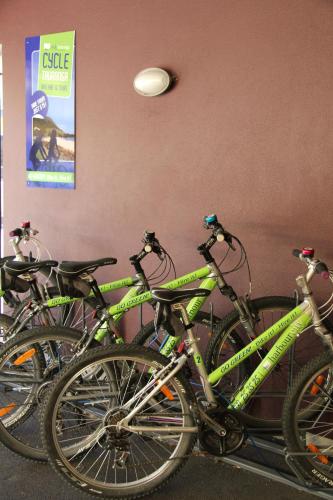 a group of bikes parked next to a wall at Harbour City Motor Inn & Conference in Tauranga