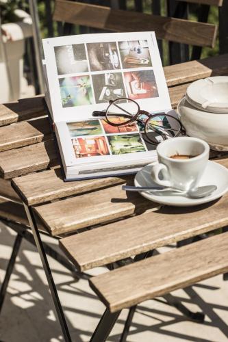a table with a cup of coffee and a magazine at Bed & Breakfast AMATI in Fasano