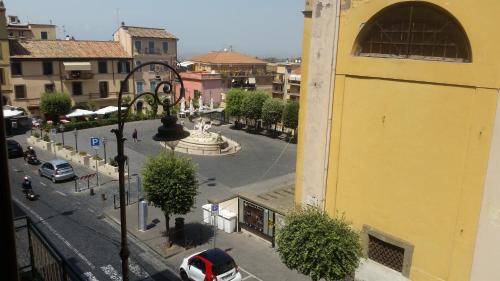 a street in a city with a yellow building at La Casa del Sire in Marino