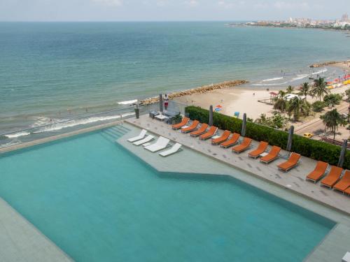 an overhead view of a pool with chairs and a beach at Luxury Alojamientos Namaste-Morros City in Cartagena de Indias