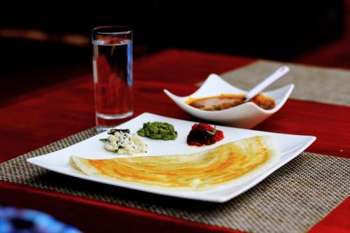 a plate of food on a red table at Peponi Living Spaces in Kigali