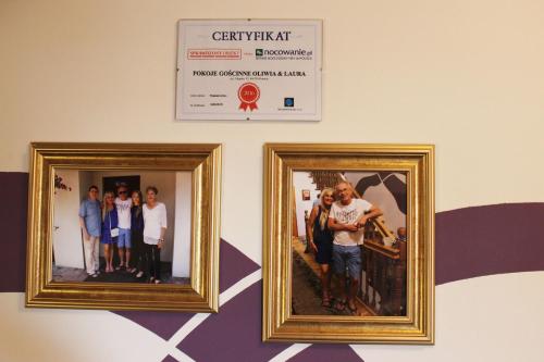 two framed photographs of a group of people on a wall at Pokoje Goscinne Oliwia & Laura II in Rumia