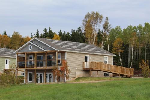 
a large house with a large wooden roof at Cape Breton Villas in Inverness
