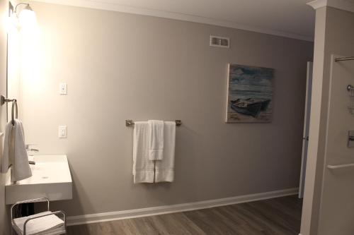 a bathroom with a white sink and a mirror at Cape Breton Villas in Inverness