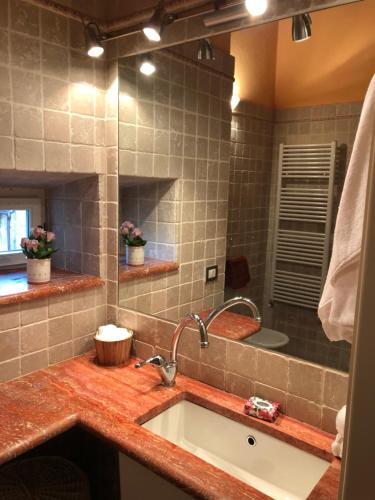 a bathroom with a sink and a mirror at Storico Loft nel Cuore di Lucca in Lucca