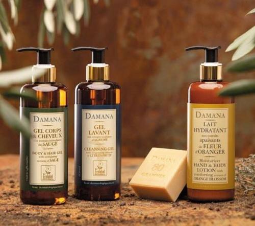 a group of four bottles of hair products on a counter at The Town Hotel Doha in Doha
