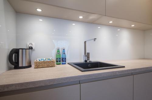 a kitchen counter top with a sink and aounter at Mariacka Old Town Apartments in Szczecin