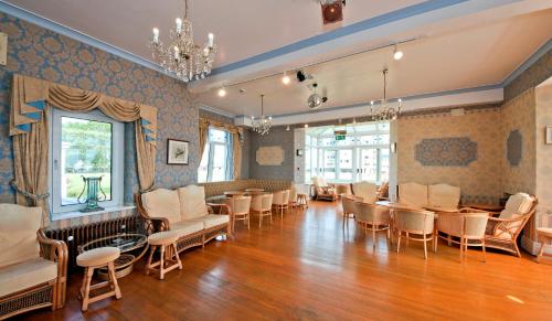 a room with chairs and tables and a dining room at Marine Hotel in Paignton