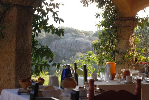 a table set up for a meal with a view at B&B La Murichessa in Arzachena