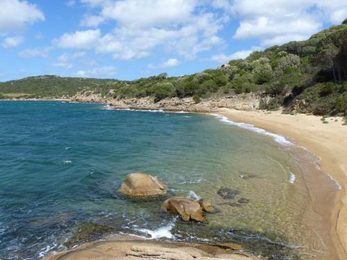 a beach with two rocks in the water at B&B La Murichessa in Arzachena