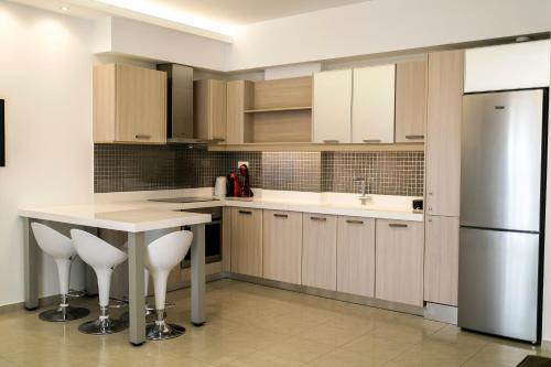 a kitchen with a white counter and a refrigerator at Kazaviti SKG in Thessaloniki