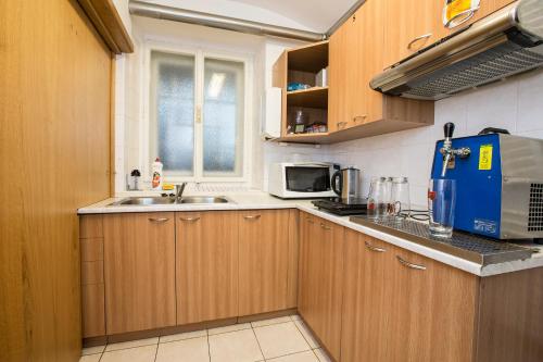 a small kitchen with a sink and a microwave at Penzion Barborka in Rokytnice nad Jizerou