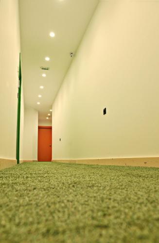 an empty room with a white wall and a red door at The Athenians Modern Apartments in Athens