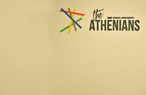 a logo for the athenians on a wall at The Athenians Modern Apartments in Athens