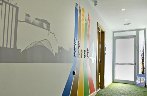 a hallway with a wall with a mural of a bridge at The Athenians Modern Apartments in Athens