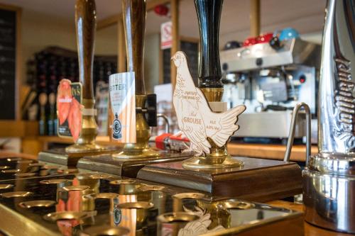 a counter with three gold things with a bird on it at Lake Vyrnwy Hotel & Spa in Llanwddyn
