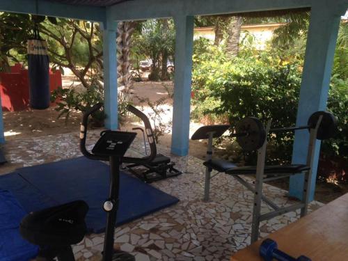 a gym with two treadmills and dumbbells at The Gunjur Project Lodge in Gunjur