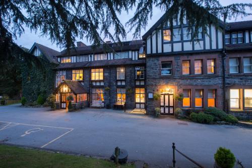 a large house with a lot of windows at Lake Vyrnwy Hotel & Spa in Llanwddyn