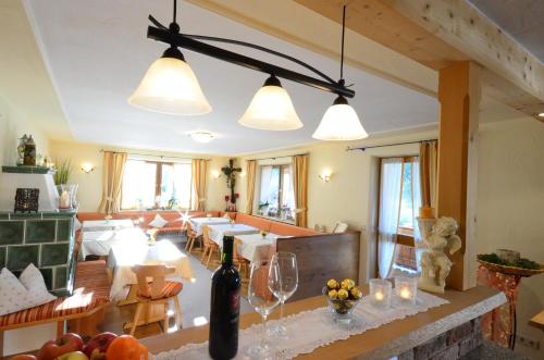 a dining room with a table with wine glasses at Gästehaus Sonnenbichl in Fischbachau