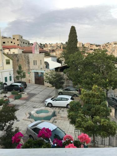 a city with cars parked in a parking lot at Al Bishara Guest House in Nazareth