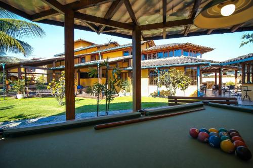 a pool table in front of a house at Pousada das Pedras Paraty -RJ in Paraty