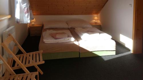 a small bedroom with a bed in a room at Apartmány Maruška in Stachy