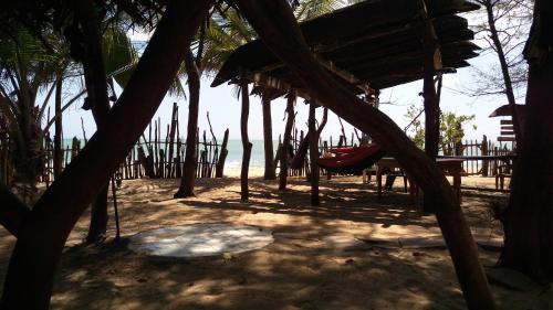 a playground with palm trees and a swing at Beach Hut in Arugam Bay