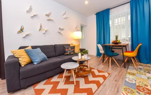 a living room with a couch and a table at Parliament & River View Apartments in Bucharest