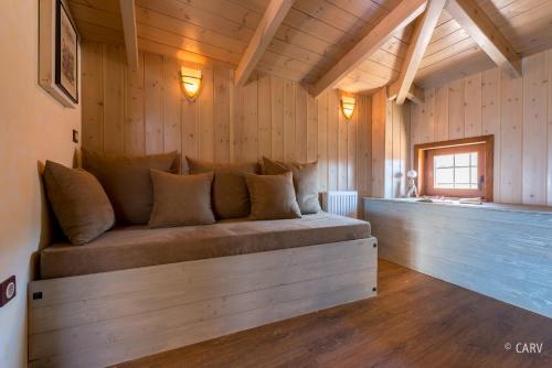 a large couch in a room with wooden walls at Kallisto Mountain House I in Arachova