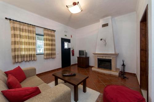 a living room with a couch and a fireplace at Naveterra-Hotel Rural in Alandroal