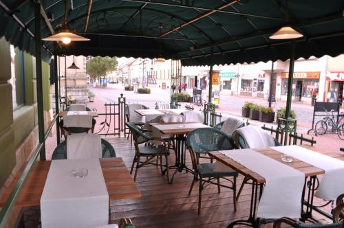 a row of tables and chairs on a patio at Grand Hotel Praha in Jičín