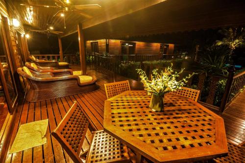 a patio with a table and chairs and a couch at Erawan Villa Hotel in Bangrak Beach