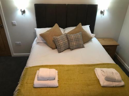 a bed with two pillows and two towels on it at Air Leth Bed & Breakfast in Portree