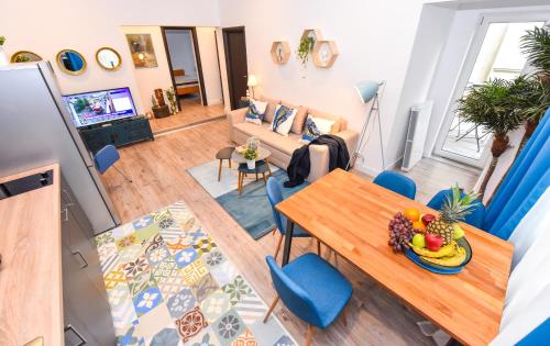 an overhead view of a living room with a table and blue chairs at Parliament & River View Apartments in Bucharest