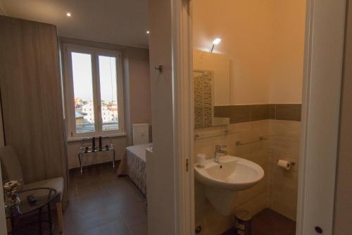 a bathroom with a sink and a window at La Terrazza di Evelina Guest House in Rome