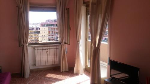 a room with a window with a view of a building at Casa Giramondo in Rome