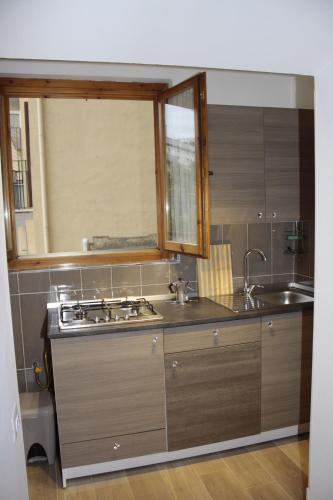 a kitchen with a sink and a stove in it at dorshaouse in Civitavecchia