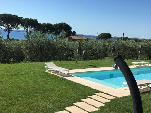 a swimming pool with two lounge chairs next to it at Agriturismo Nonna Bettina in Moniga