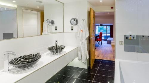 a bathroom with a sink and a mirror at Applegarth Villa Hotel & Restaurant (Adult Only) in Windermere