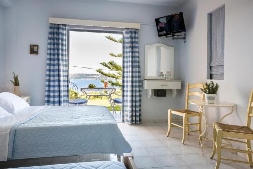 a bedroom with a bed and a view of the ocean at Panorama Fanari studios and apartments in Argostoli